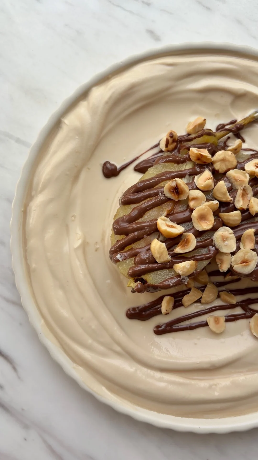 Poached pear with coffee mascarpone, hazelnut cream and roasted hazelnuts in the Eataly London recipe